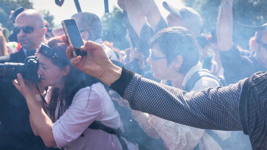 Person using phone to record in a crowd